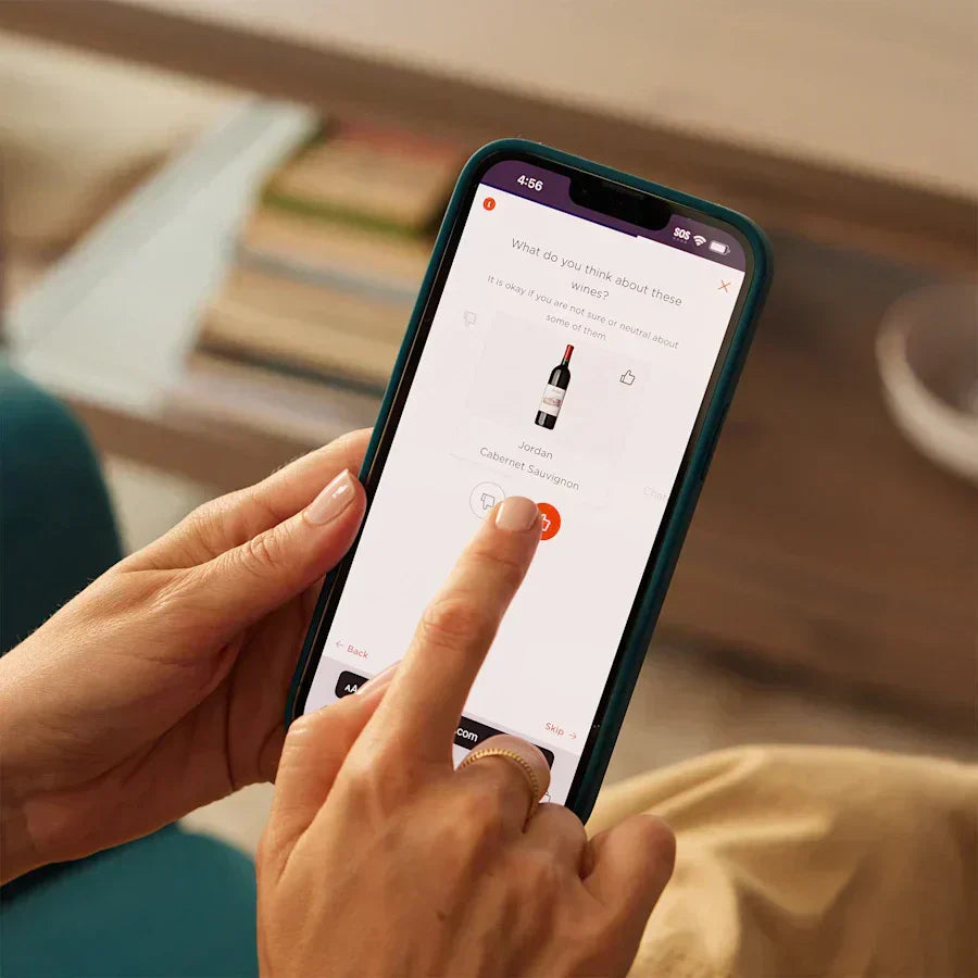 Hands holding a phone with the Firstleaf app.