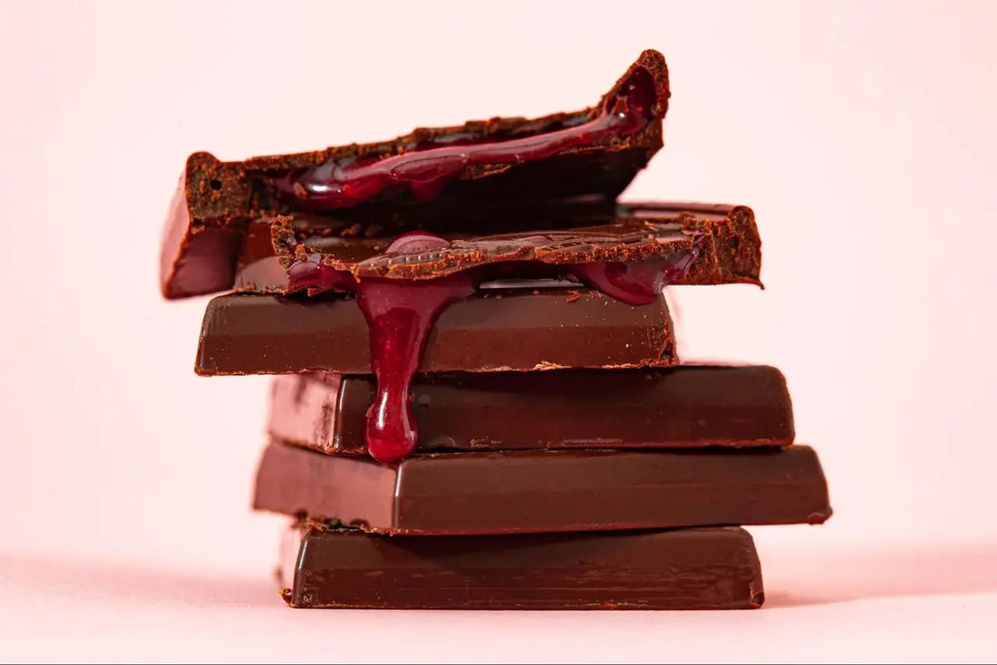 Stack of fruit-filled chocolate on a pink background