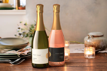 Two bottles of cava on a table