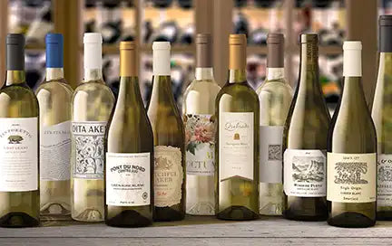 Several bottles of white wine lined up in a wine store.