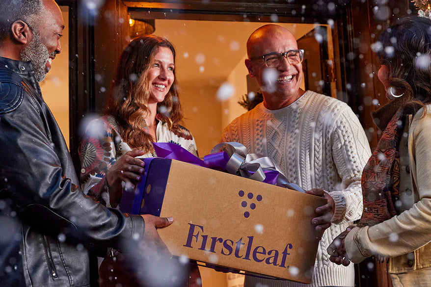 4 people with a firstleaf box in the snow