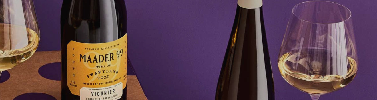 Wine bottle with 'Maader' label and wine glass on a purple background