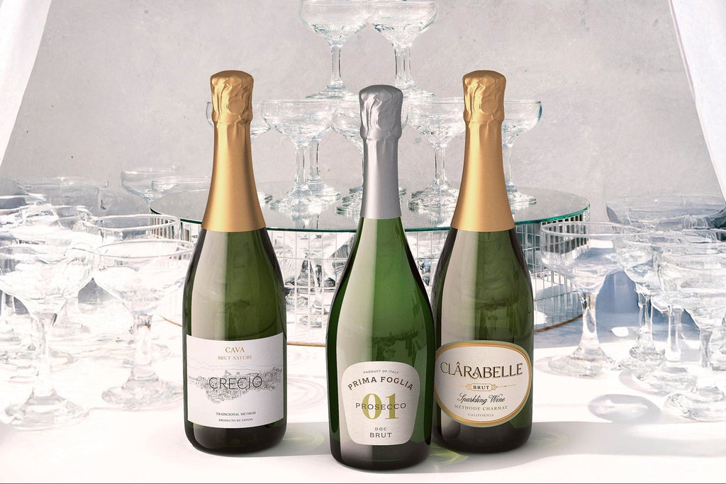 2 bottles of premium sparkling wine in front of a tower of coupe glasses