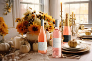 Three bottles of rosé on a table set for Thanksgiving